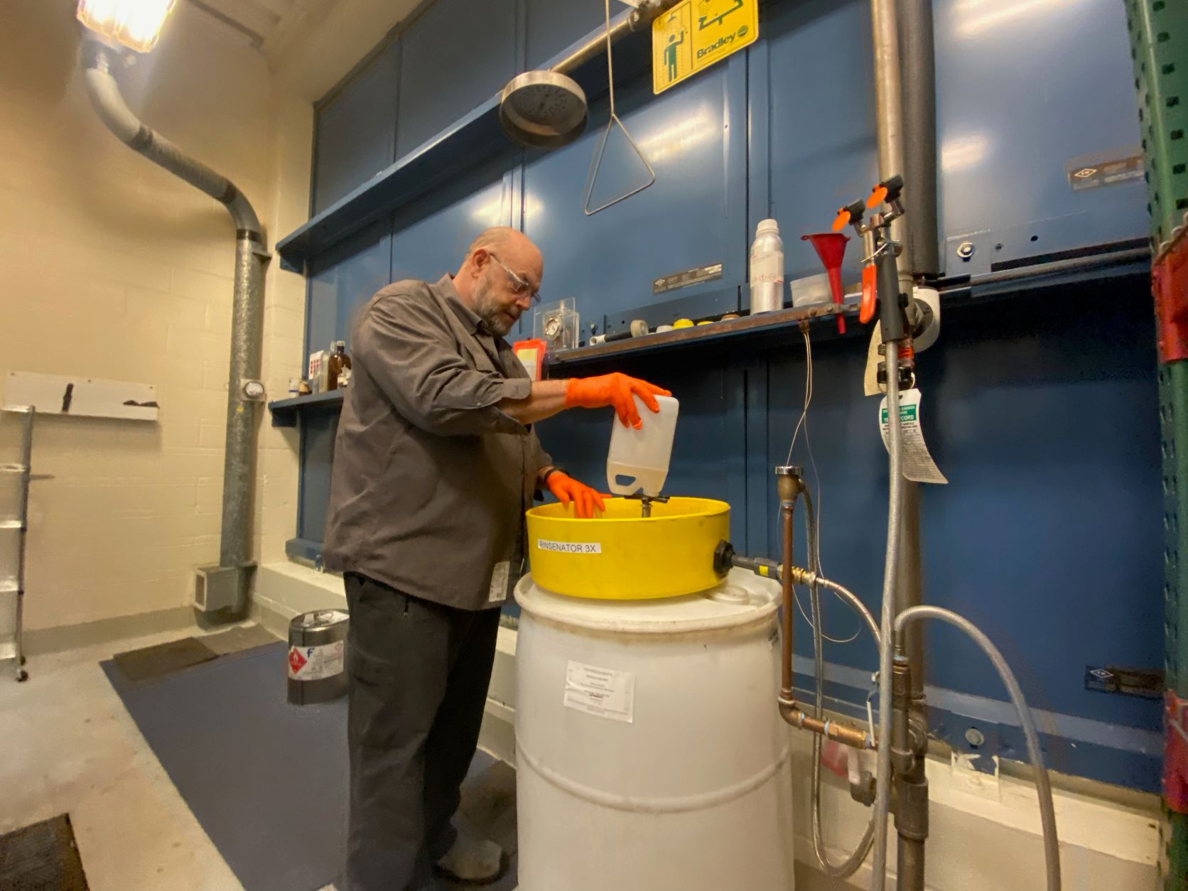 Pete Schoonover cleans chemical containers using a custom tool he built . 