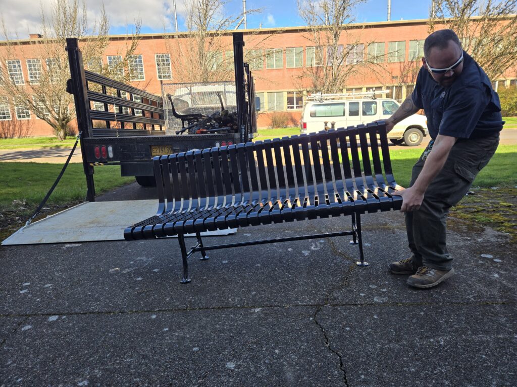 An employee moving a bench.
