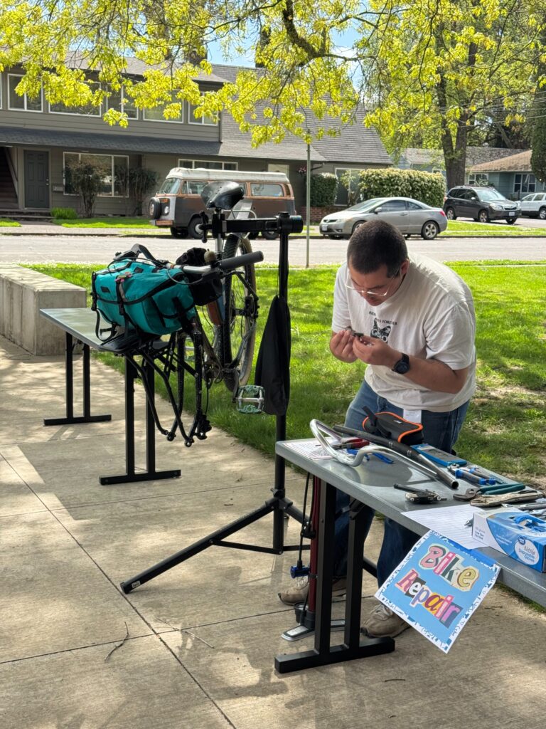 A person volunteering at a bike repair station. 