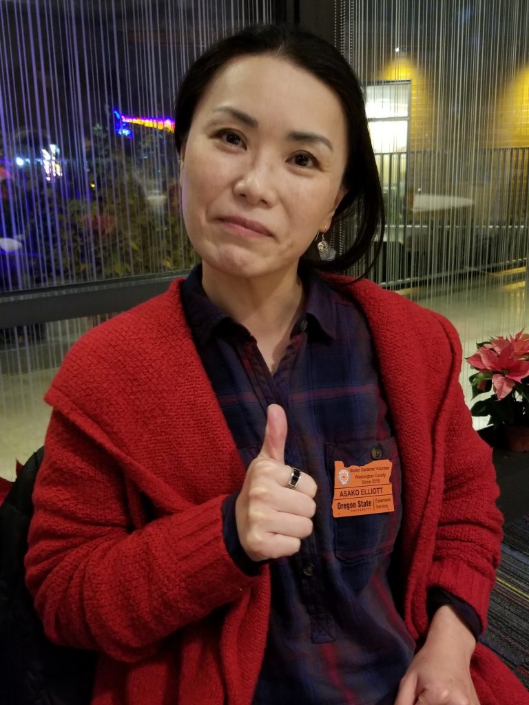 2018 Master Gardener gives thumbs up as she proudly wears her OSU Master Gardener badge