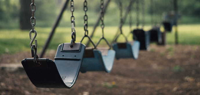 close up of swings in empty playground