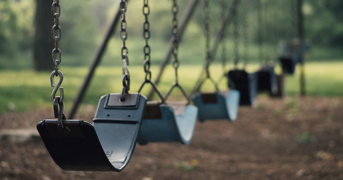 close up of swings in empty playground