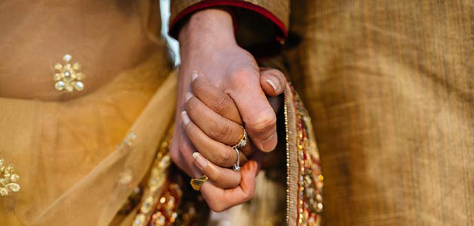 Indian man and woman holding hands
