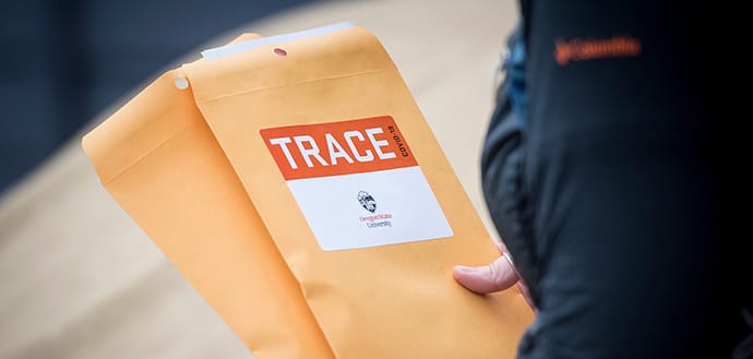 worker holds TRACE envelopes