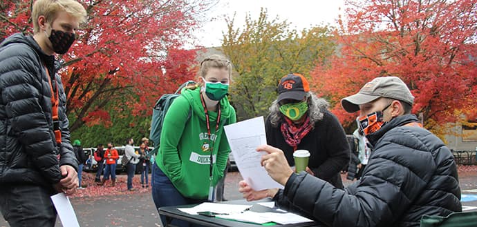 OSU and UO students wearing masks going over TRACE-COVID-19 project duties with project leader Jeff Bethel