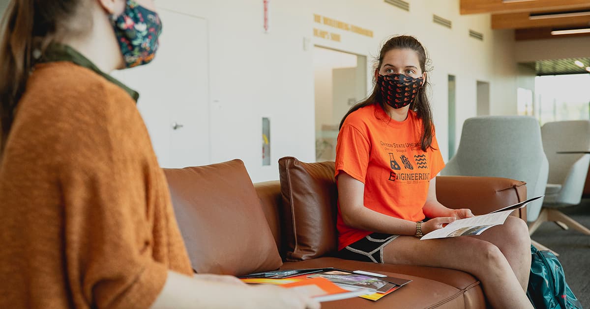 students wearing beaver nation face masks study in common area during fall semester