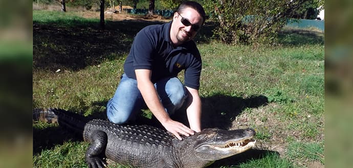 Ryan Scholz poses with alligator