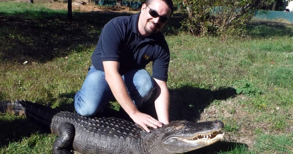 Ryan Scholz poses with alligator