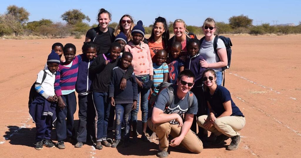 CPHHS students pose with Botswana youth during the 2019 study abroad trip.