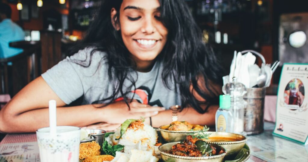 girl about to eat Indian food