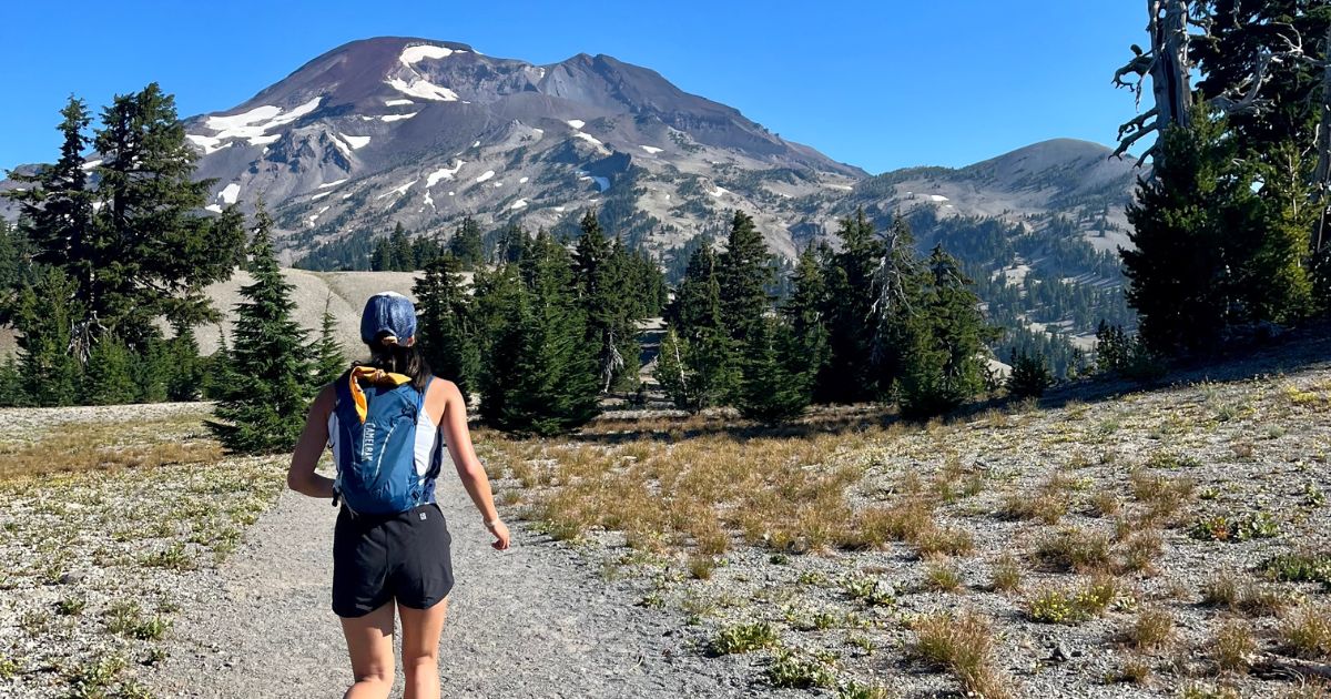 Woman trail running toward mountain