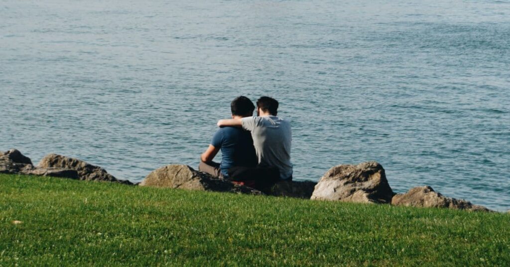 two men near a body of water