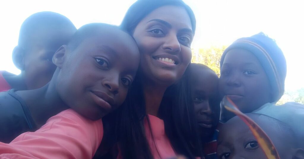 Divya with children in Botswana.