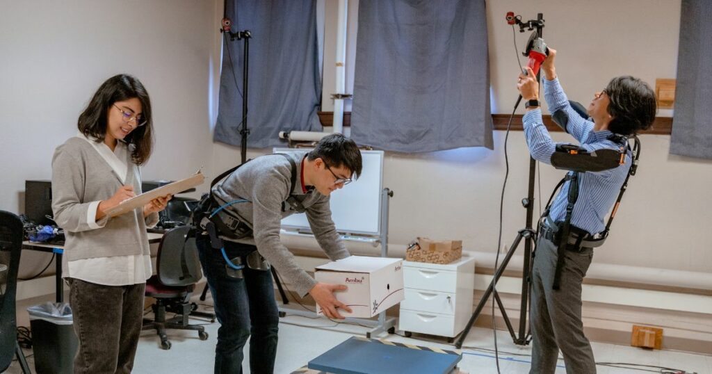 Ph.D. advisor Jay Kim assists doctoral students in setting up an experiment in the Occupational Ergonomics and Biomechanics Lab.