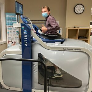 Riley, a kinesiology student who wants to become a physical therapist, running on an antigravity treadmil.