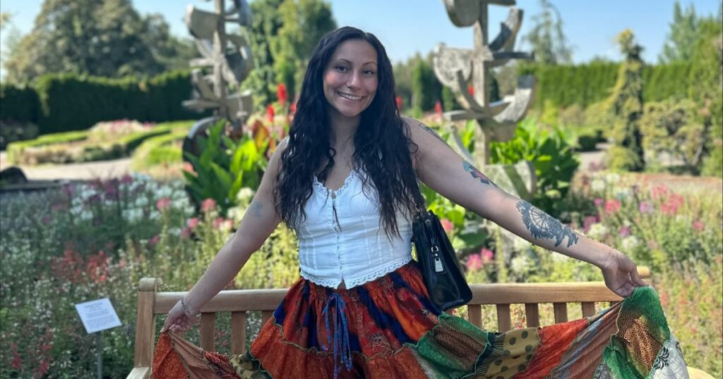 Photo of Faith in a traditional skirt in a garden