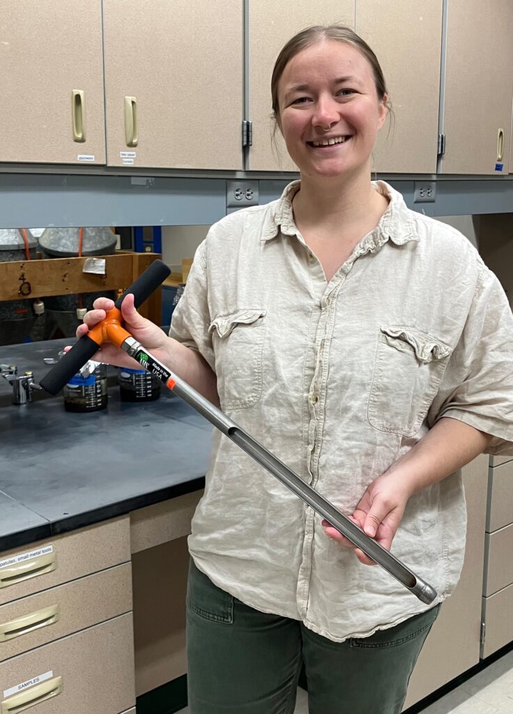 Fig. 3: Anna Perry holding a soil probe
