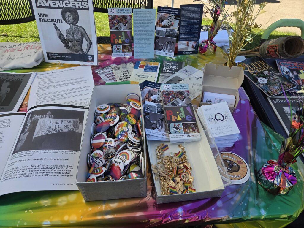 OSQA Booth - free pride pins and OSQA mini-zines