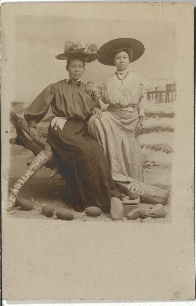 Postcard photograph, a portrait of two women in an a prop beach setting