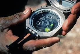 A member of the Combat Control Pararescue Indoctrination School, Lackland Air Force Base, uses a Brunton compass to determine the direction of a recently released weather balloon during a joint Army/US Air Force Reserve combat control team medical exercise