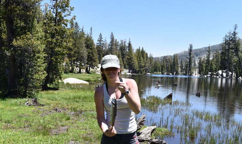 Anita McNally shows a recently caught trout.