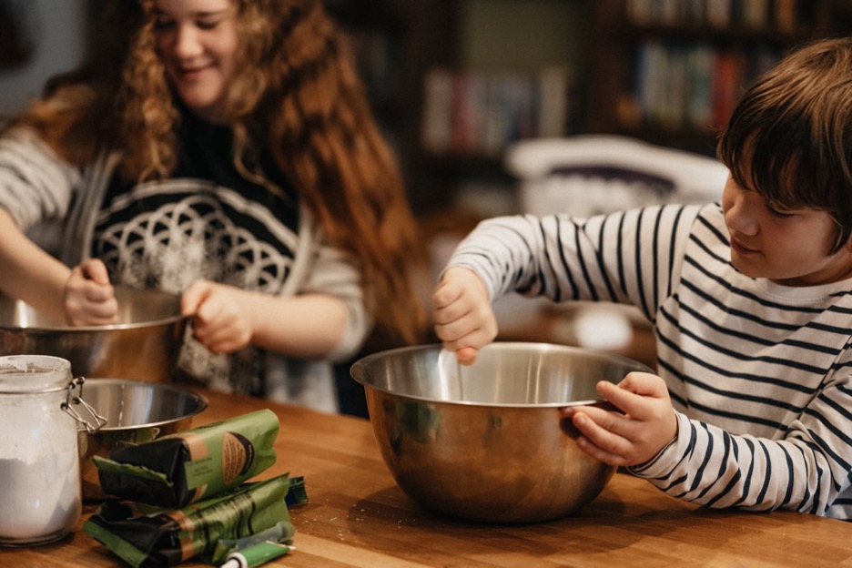 Two people stirring in bowls