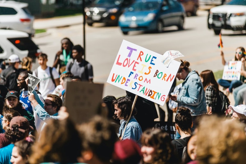 Protester holding a “True love is born from understanding” sign