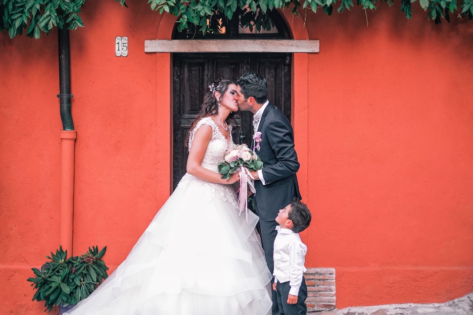 A couple at a wedding with a child.