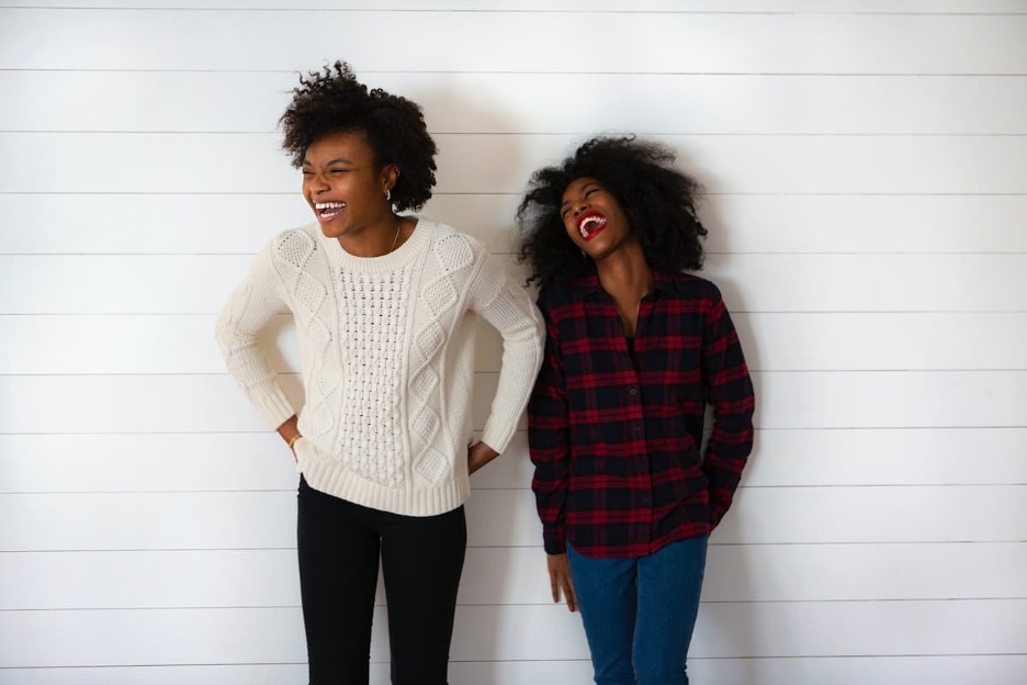 Two young Black people laughing