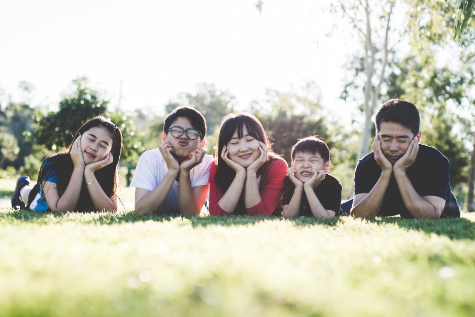 A family of 5 making silly faces at the camera