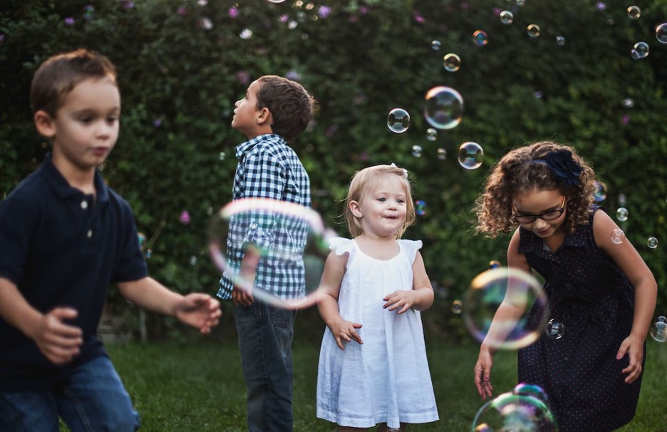 A group of children playing with bubbles.