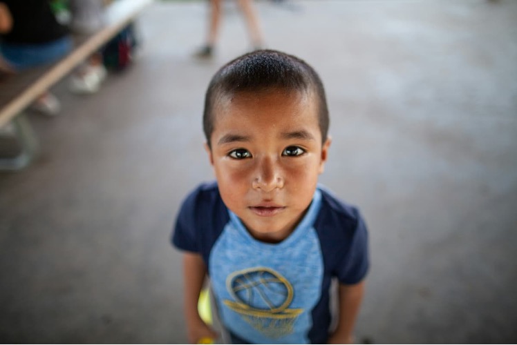 Child looking up at the camera.