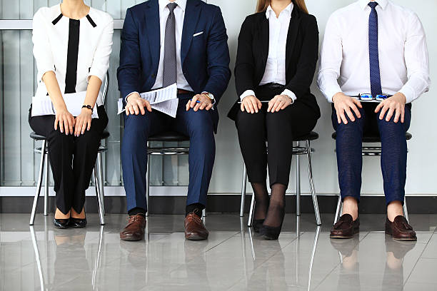 Business people waiting for job interview. Business people waiting for job interview. Four candidates competing for one position formal interview stock pictures, royalty-free photos & images
